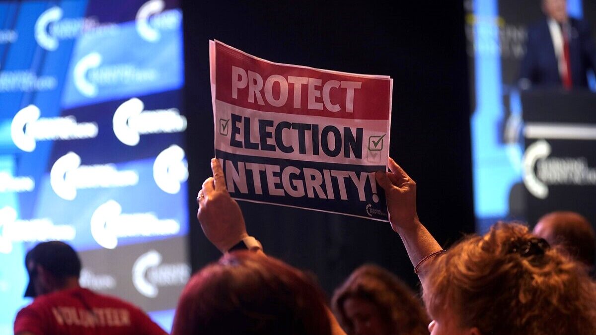 Person holding Election Integrity sign